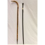 Black finished vintage walking stick with a carved Oriental style wooden handle together with Wooden