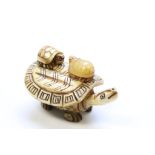 Bone figure of a Turtle carrying two turtles on back