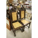 Pair of 17th century Style Heavily Carved Oak Hall Chairs, each with a panel carved with a different