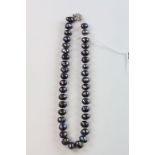 Row of black baroque pearls