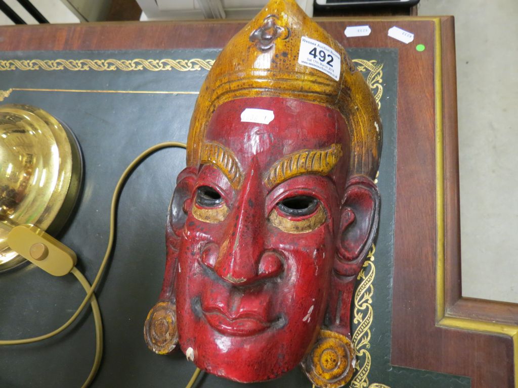 An Asian carved wooden mask