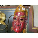 An Asian carved wooden mask