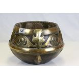 An antique wooden bowl with brass strapwork decoration, possibly Persian or North African