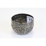 Vintage unmarked Asian white metal bowl with repeated floral pattern