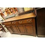 18th century Oak Dresser Base with Three Drawers above four cupboard doors raised on bracket feet