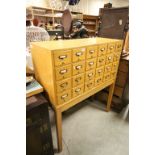 Mid 20th century Pale Oak Bank of Twenty-Four Filing Drawers made by ' Serota, London ' raised on