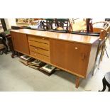 Retro Teak Effect Side Board with central bank of four drawers flanked by two sliding doors