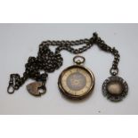 Gold plated small pocket watch together with a silver watch chain and silver fob, stylised acorn