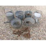 Two Galvanised Watering cans, four buckets and a metal wheel