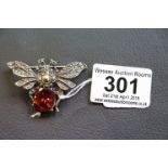 Silver bug brooch set with large red stone and marcasite