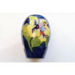 Moorcroft hibiscus vase, blue ground with red and yellow hibiscus flowers, impressed marks to