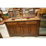 18th century Oak Dresser Base with Three Drawers above four cupboard doors raised on bracket feet