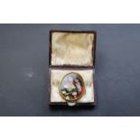 Late Victorian/Edwardian reverse painted cameo brooch depicting courting couple in yellow metal