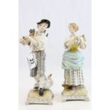 Pair of 19th Century figurines, depicting a maid with basket of fruit and a man with pair of