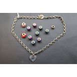 Belcher link necklacae with heart shaped pendant and assorted enamelled and glass bead charms marked