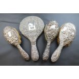 Three white metal brushed together with a white metal hand mirror, with mask and bird repousse