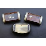 Two wooden and white metal snuff boxes one inlaid with cherub, the other with shamrock and a horn