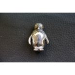 Silver figure of a penguin with ruby eyes