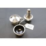 A matched three piece silver cruet set, bakelite lined, comprising salt, pepper and mustard,