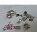 A collection of charms to include articulate ball fobs, boot, parrot, enamelled crucifix, Robin