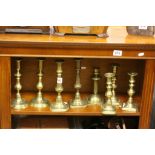 Eight assorted brass candlesticks