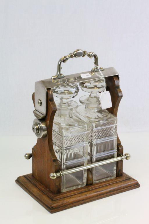 Oak & Silver plated two bottle Tantalus with original cut glass Decanters