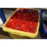 Large tubs of red Lego bricks