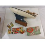 Toy sailing boat, boxed metal puzzles game and boxed Rhymo Dominoes, all circa 1950s