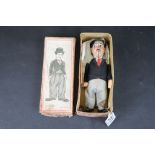 Boxed Schuco Charlie Chaplin B/1454/1 tin plate clockwork figure in black jacket with red tie, tin