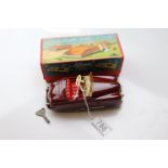 Boxed Schuco Radio 4012 clockwork diecast car in maroon with key 'Rock A Bye Baby' Thorens