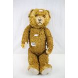 Early 20th C straw filled teddy bear, showing some wear, with both eyes, 21" in approx height