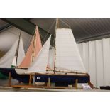 Scratch built sail boat in good condition on wooden plinth, approx length 30 inches