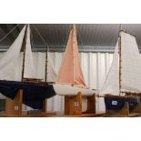 Scratch built pond yacht in good condition, on wooden plinth, approx length 23 inches