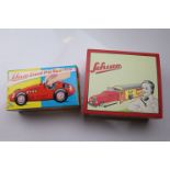 Boxed Schuco Garage (reproduction) with red vehicle and a boxed Schuco Grand Prix Racer 1070 in