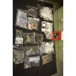 Collection of plastic model kits in sealed bags plus slot car accessories