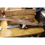 Large carved Wooden model of an Eagle with outstretched wings and on a Wooden log base