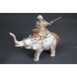 Cast metal painted Arab figure holding musket seated on an elephant with raised trunk, circa 1920s/