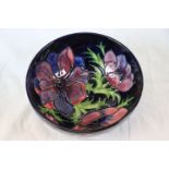 Moorcroft anemone pattern bowl, blue ground with red and purple anemone decoration, impressed and