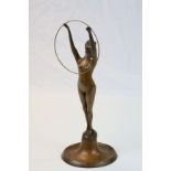 Art Deco bronze figure of a nude female with head tipped back and arms outstretched supporting a