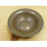 Hugh Wallis: an Arts and Crafts planished copper bowl, the centre with incised circular surround,