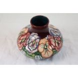 Moorcroft pansy vase of squat melon form, burgandy ground with red, purple and orange pansy