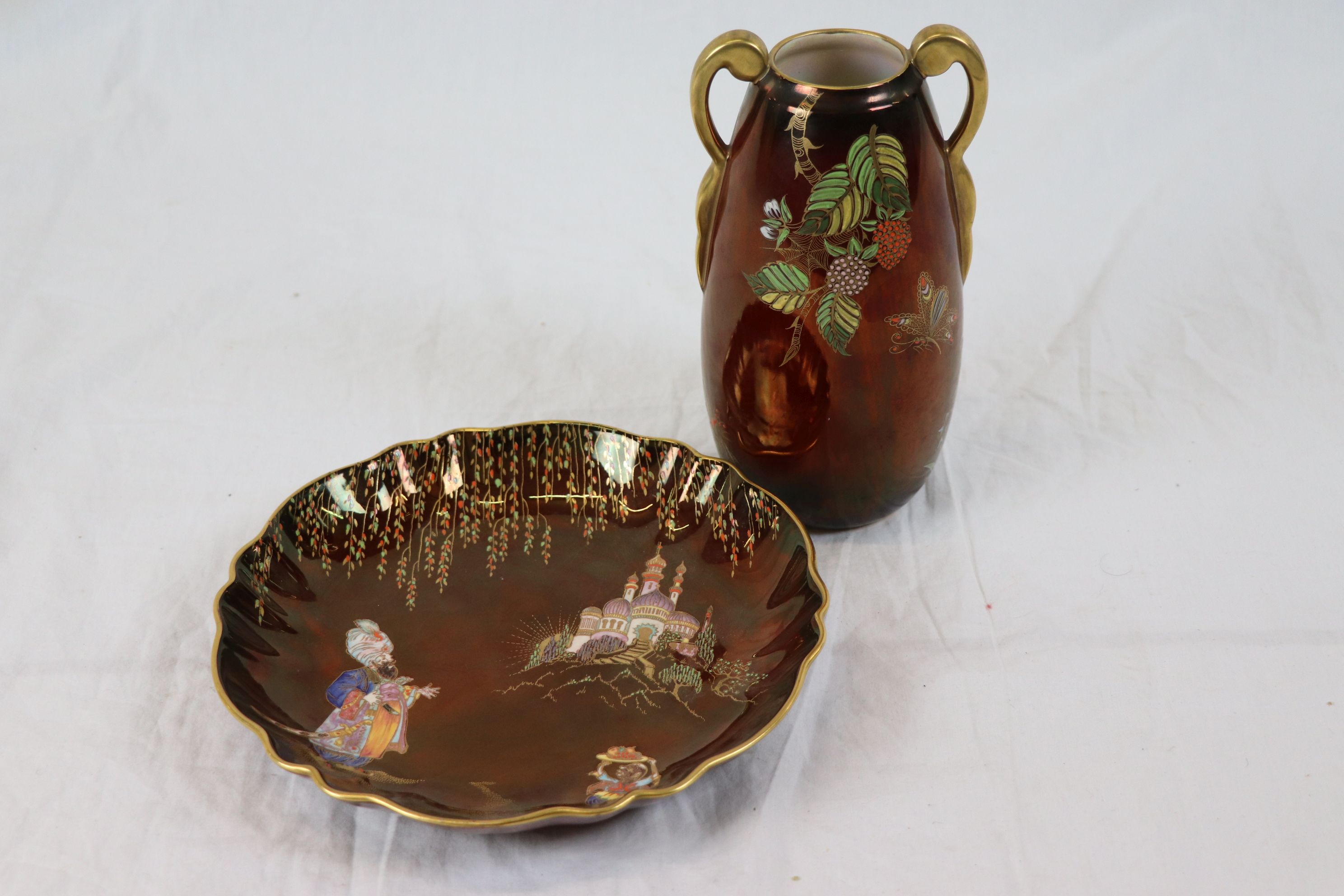 Carltonware hand painted plate with gilt ogee style border and red ground, depicting Indian