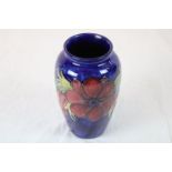 Moorcroft Anemone vase, blue ground with red flowers, height approximately 21.5cm, impressed and