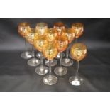 Eleven hock glasses, irridescent orange ribbed bowl with colourless stem and foot, height