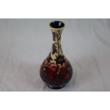 Moorcroft vase of baluster form, cream and red ground with trailing purple and yellow centred