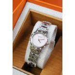 A ladies Hermes wrist watch with pink face. Comes with box and international guarantee stamped