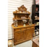 Victorian Walnut Chiffonier, the upright back with two shelves and carved floral swags and