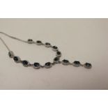 An impressive silver CZ and iolite paneled necklace.