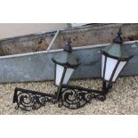 Pair of Iron Framed Street Lanterns each held on an Iron Wall Bracket with a Bird Design