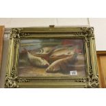 A gilt frame oil paintings study of freshwater fish on a riverbank.